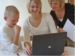 Kid and parent with computer